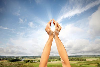 Hands Cupping Sun - Solar Power Ovens